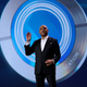 Carnival CEO Arnold Donald holds up the Ocean Medallion wearable for cruise ship passengers, during his 2017 keynote at CES in Las Vegas
